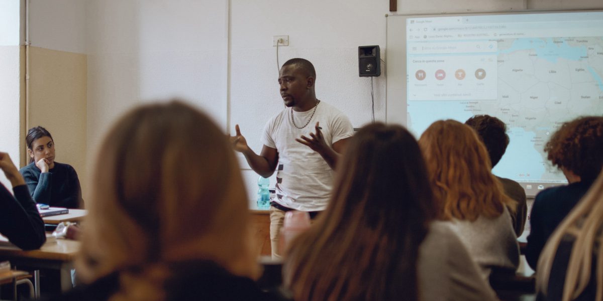 A migrant from Cameroon gives a talk in an Italian school to break down barriers.